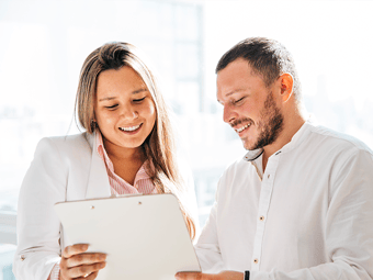 Website Icon_ Woman and man holding clipboard smiling discussing-1