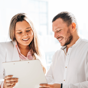 DOC_KC_PNG_Stock_woman and man smiling and looking at tablet